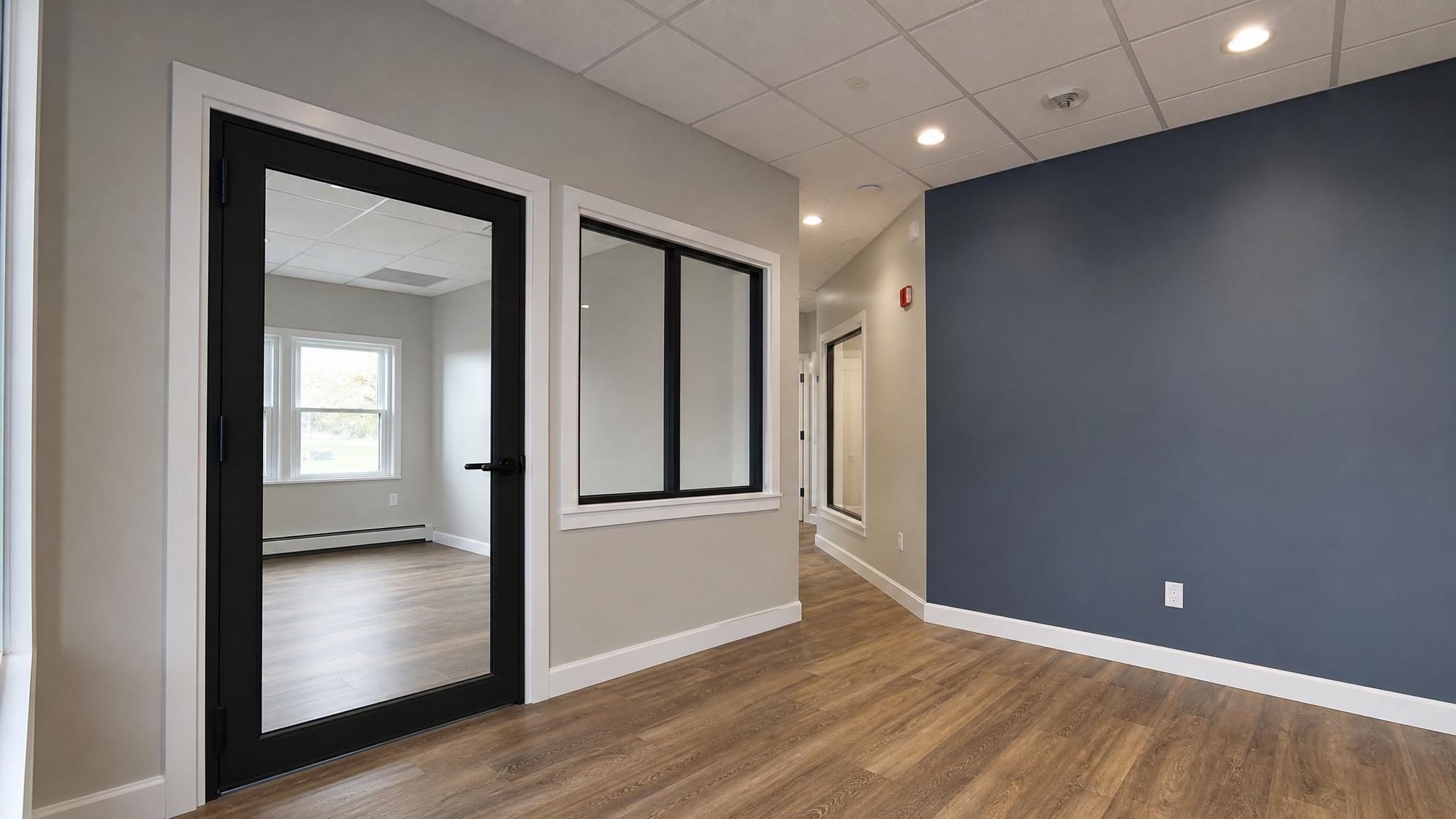Finished commercial interior with freshly painted wall, door, and trim.