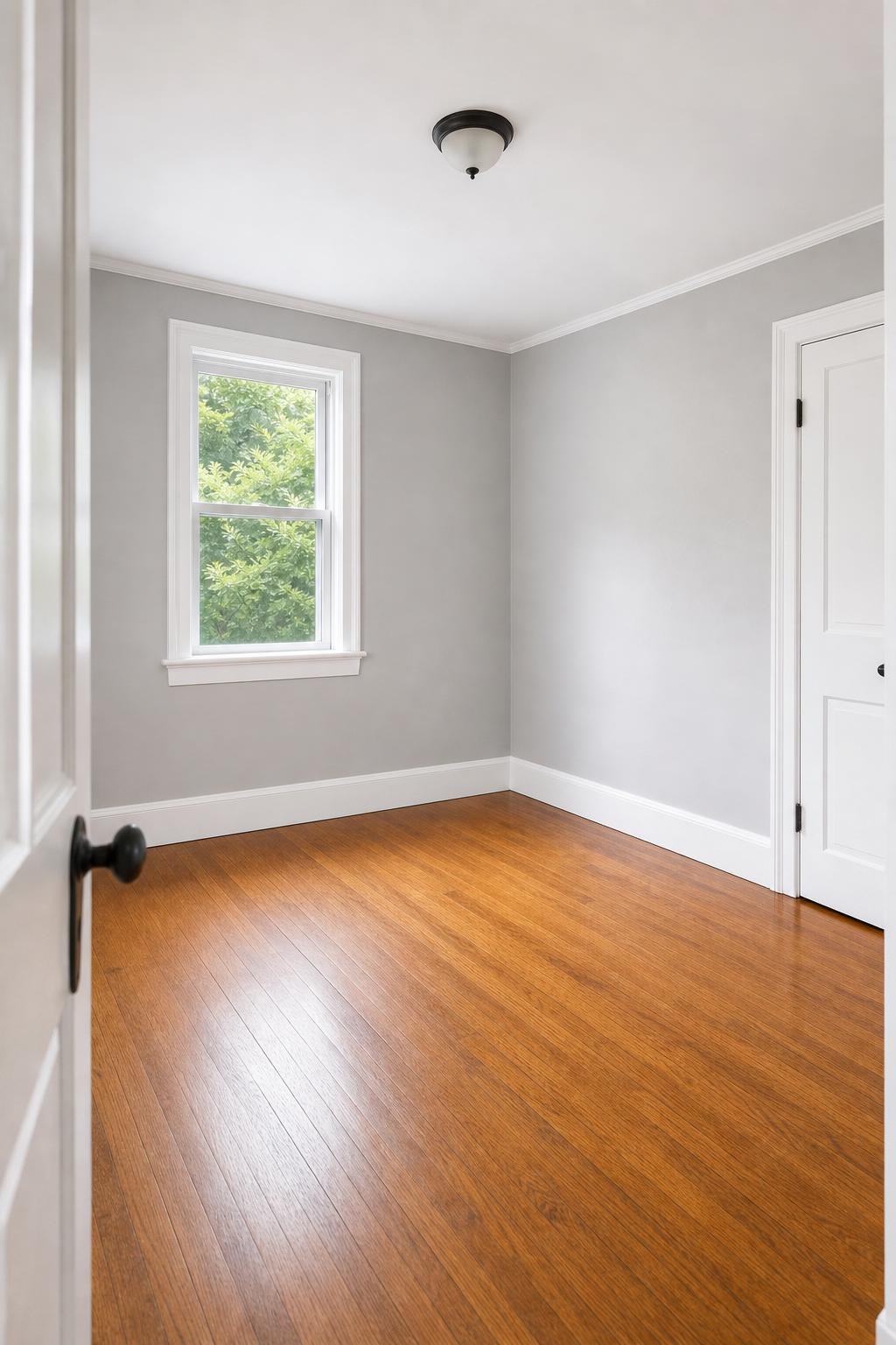 Full trim repair project with finished baseboards, window trim, wall, and floor context.